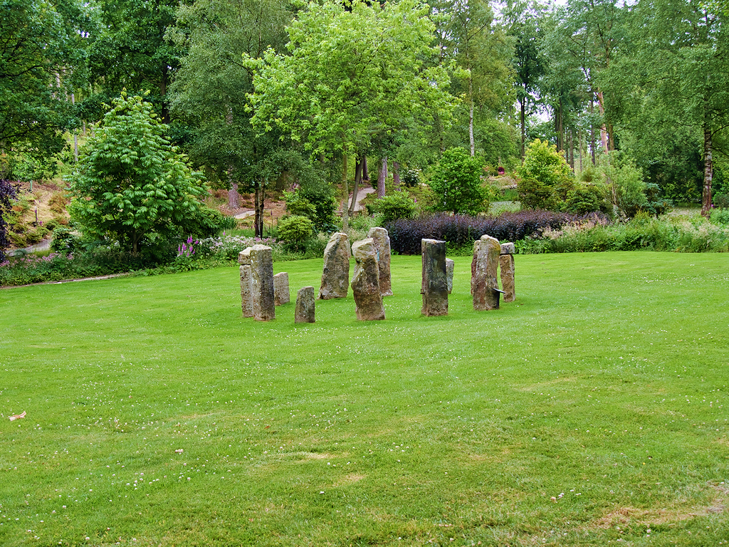Stone circle in a garden setting, suggesting ceremonial outdoor space